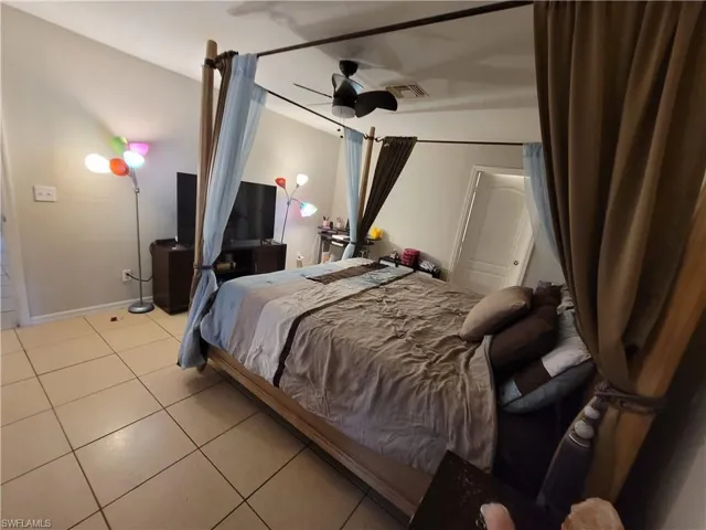 Bedroom with tile floors and ceiling fan