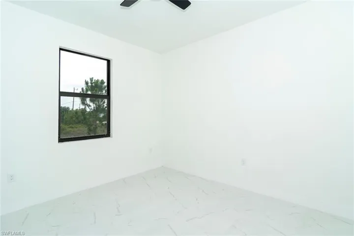 Empty room with baseboards and light marble finish floors