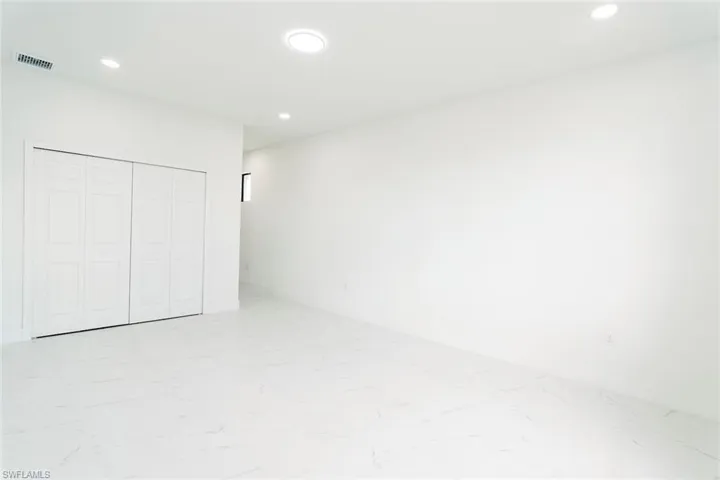 Unfurnished bedroom featuring recessed lighting and a closet