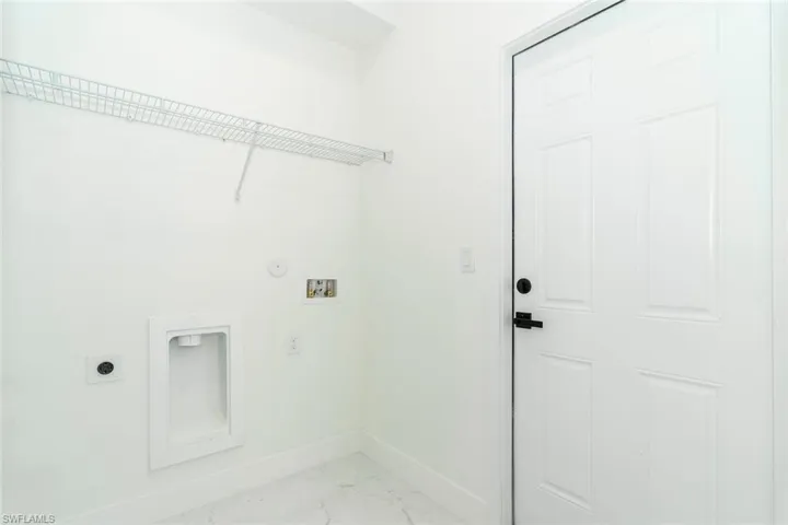 Washroom featuring light marble finish floors, electric dryer hookup, washer hookup, and hookup for a gas dryer