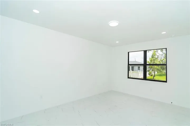 Spare room with recessed lighting and baseboards