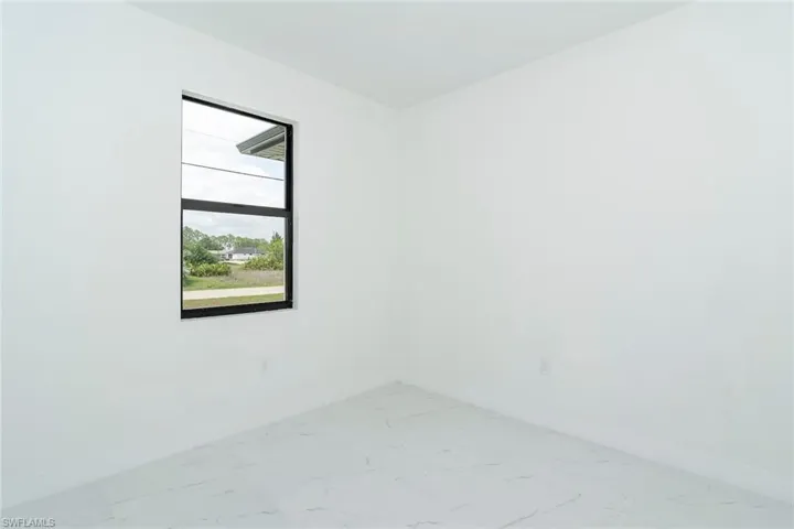 Unfurnished room with baseboards and light marble finish flooring