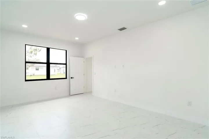 Empty room with baseboards and recessed lighting
