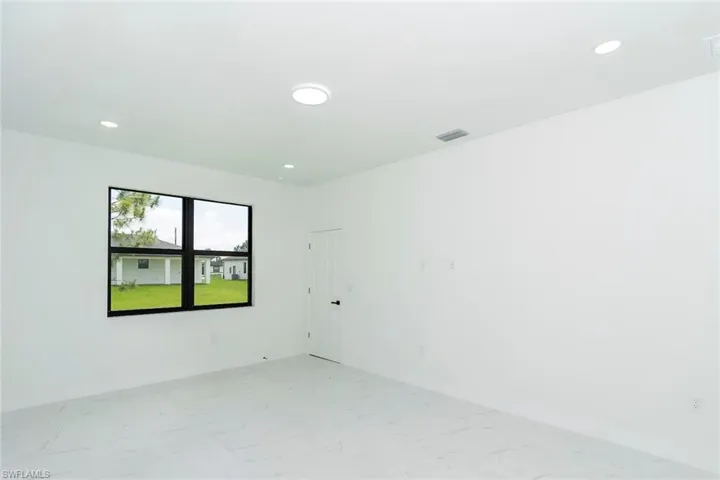 Spare room featuring light marble finish floors and recessed lighting
