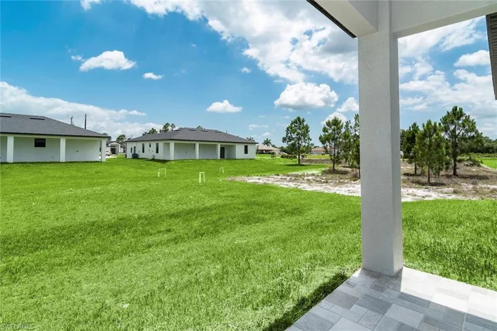 View of green lawn featuring a patio area