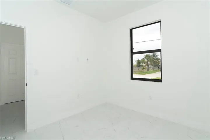 Spare room with light marble finish flooring
