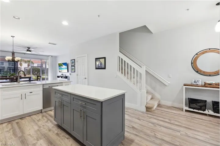 Kitchen with light hardwood / wood-style flooring, sink, pendant lighting, dishwasher, and gray cabinets