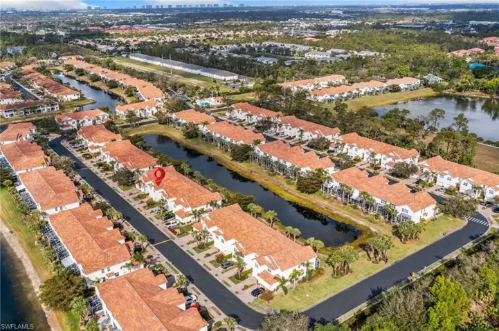 Birds eye view of property with a water view