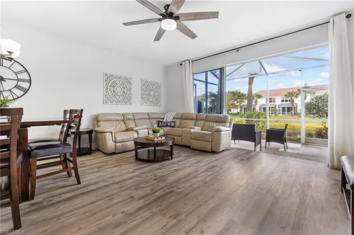 Living room with ceiling fan, plenty of natural light, and hardwood / wood-style floors