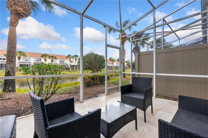 Sunroom with a water view and a healthy amount of sunlight