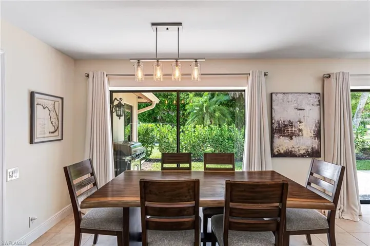 Dining space with light tile patterned flooring