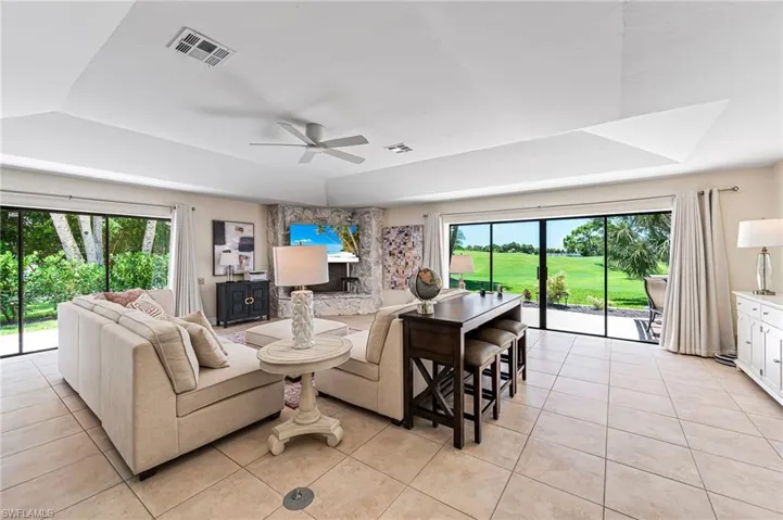 Tiled living room, two walls of sliders and maginficent golf course views.