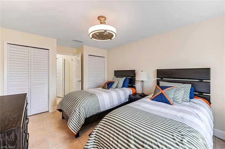 Twin bedroom with multiple closets