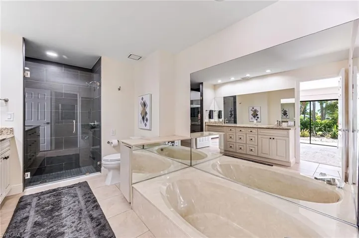 Walk in shower, oversized bathtub, double sink vanity and walk in closet.
