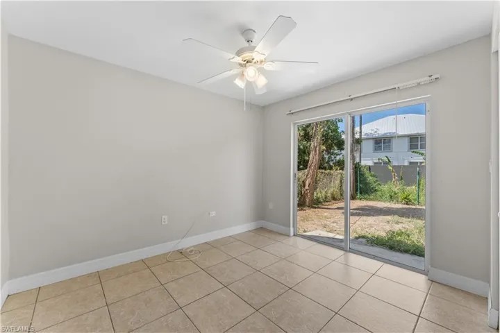 Empty room featuring baseboards, ceiling fan, and tile patterned flooring