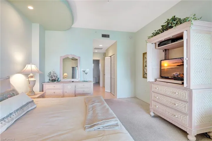 Bedroom featuring a closet, visible vents, and light colored carpet