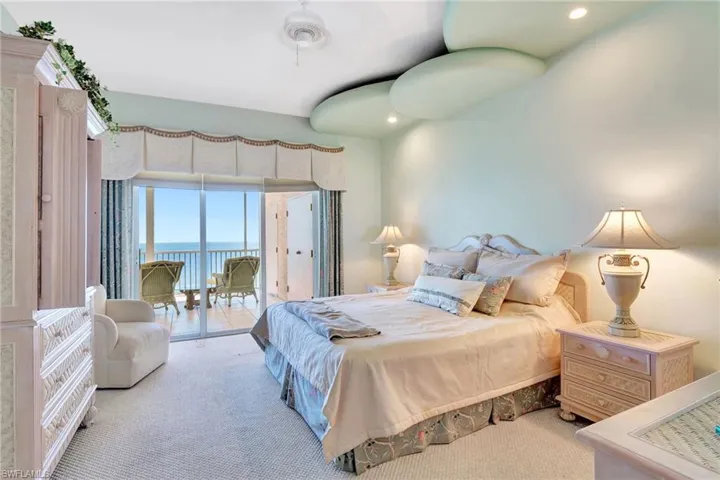 Bedroom with carpet flooring, a water view, access to exterior, and recessed lighting