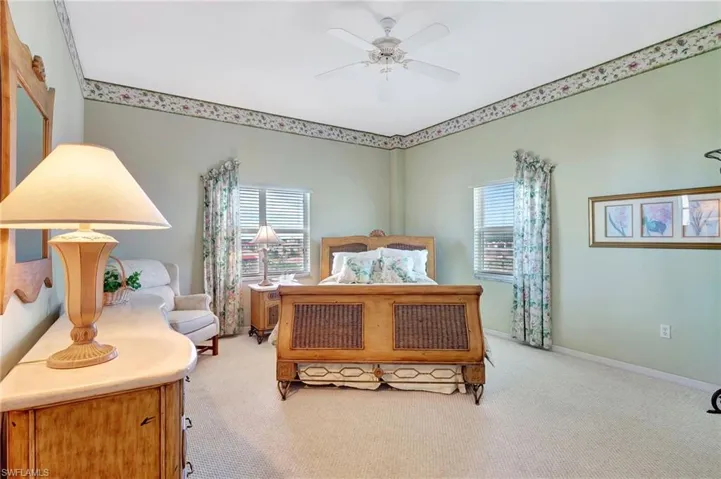 Bedroom featuring baseboards, ceiling fan, and carpet flooring