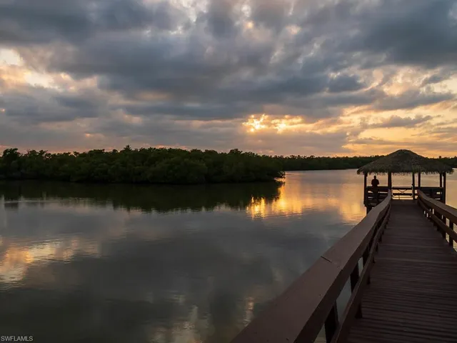Expansive water frontage featuring a private wooden pier