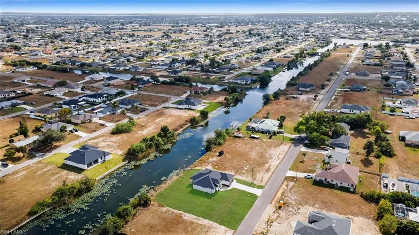 Aerial view of property's location with nearby suburban area and a large body of water
