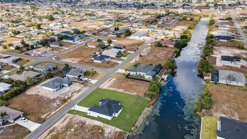 Aerial view of property's location with nearby suburban area