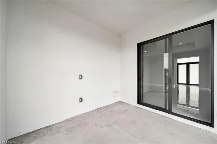 Spare room featuring concrete flooring