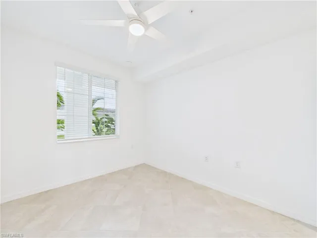 Unfurnished room with baseboards and a ceiling fan