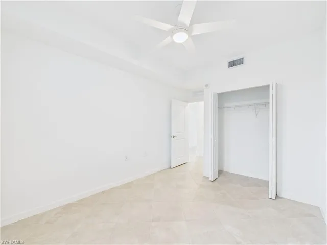 Unfurnished bedroom with a closet and a ceiling fan