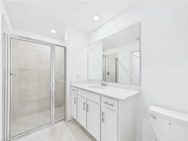 Bathroom with vanity and a shower stall