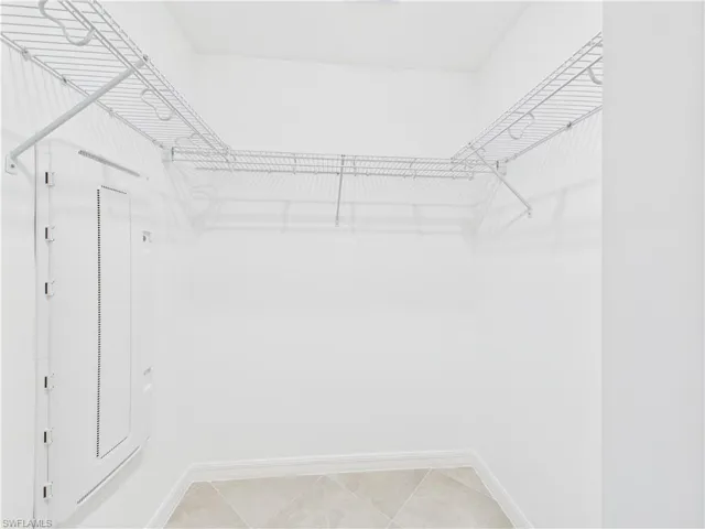 Walk in closet featuring light tile patterned flooring