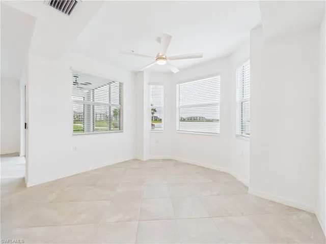 Spare room featuring ceiling fan and light tile patterned flooring