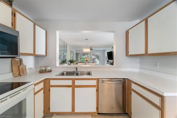 Kitchen featuring appliances with stainless steel finishes and light countertops