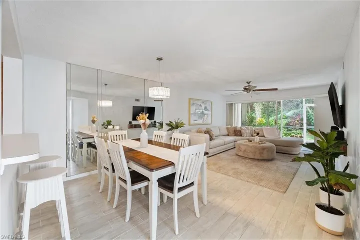 Dining space with light wood-style floors and ceiling fan