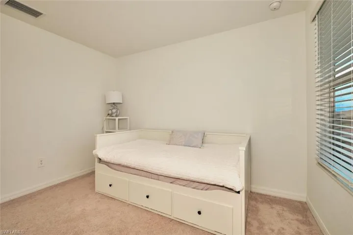 Bedroom with carpet floors and baseboards