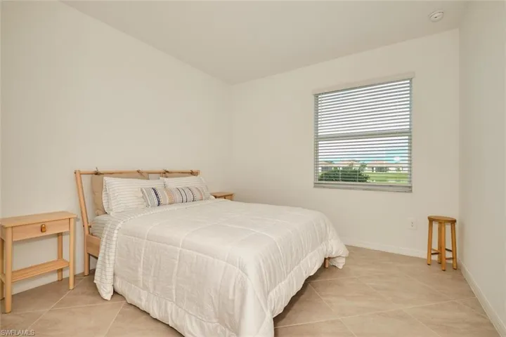 Bedroom with light tile patterned flooring