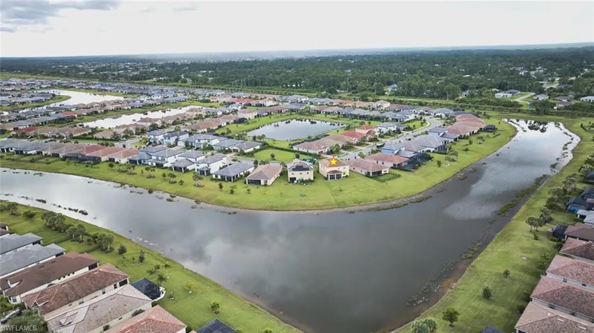Aerial view of property's location with nearby suburban area and a large body of water