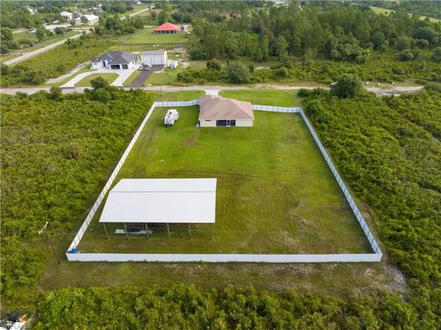 Aerial View from rear showing 6ft privacy fencing, Pole Barn, and Home
