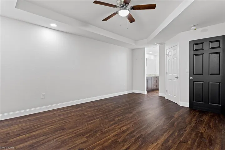 Primary Bedroom with walk-in closet and coffered ceilings.