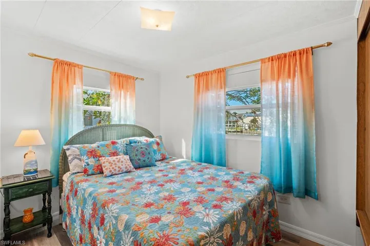 Guest bedroom with queen bed and view to water
