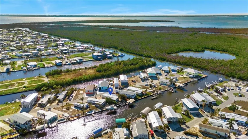 Birds eye view of property with a water view