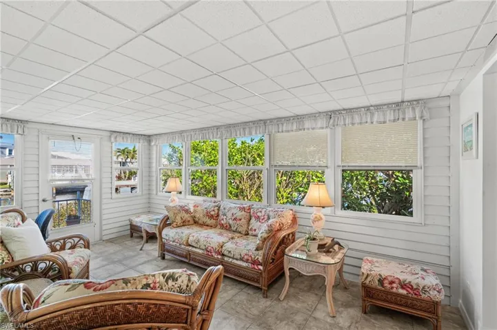 Sunroom with plenty of windows and view with access to back patio