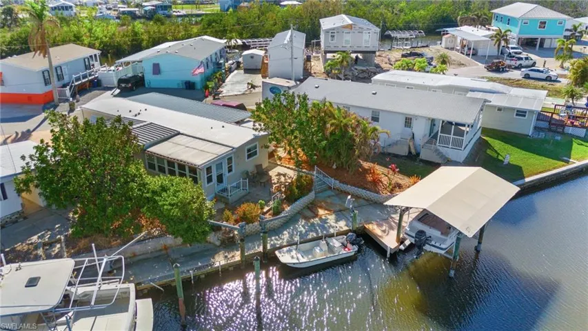 Birds eye view of property showing covered boat lift and davits for boating access