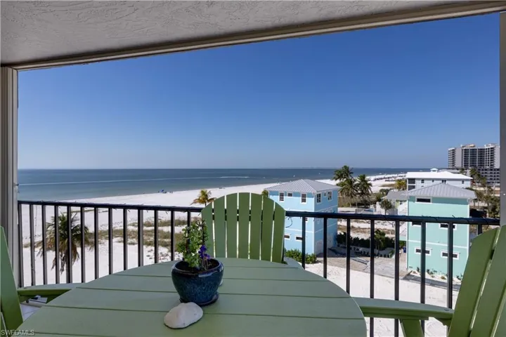 Balcony with view of water and beach