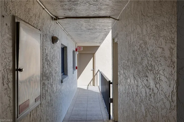 View of hall leading to entry door
