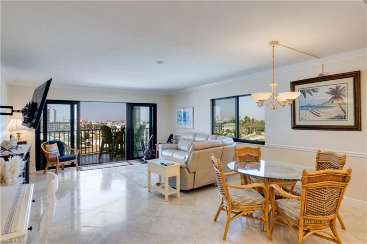 Dining area with a healthy amount of natural light, and a chandelier
