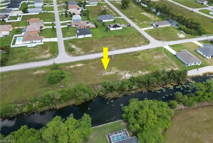 Aerial overview of property's location featuring a nearby body of water and nearby suburban area