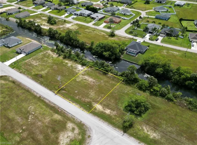 Aerial perspective of suburban area featuring a large body of water