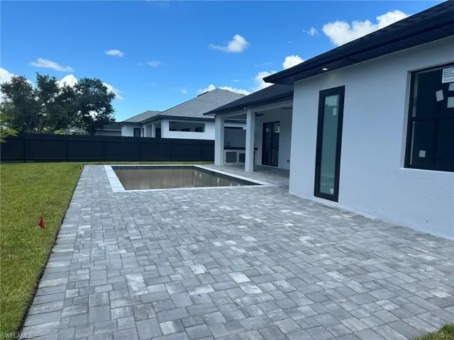 View of pool featuring a patio and a lawn