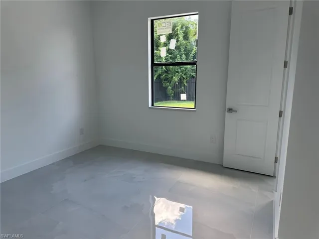 Tiled spare room featuring plenty of natural light