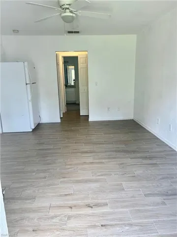 Spare room with light wood finished floors and a ceiling fan